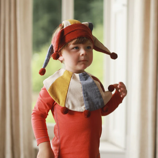 A young joker shows the jester set as worn with his red t-shirt 